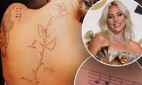 The first is an outline of a rose running the length of her spine with the words, la vie en rose, referencing the edith piaf song of the same. Lady Gaga Quickly Fixes Mistake On New Music Note Ink After Getting Two V Day Tattoos Daily Mail Online
