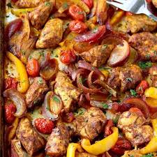 View Of Seasoned And Cooked Chicken Tenders Sliced Red Onions Sliced Yellow Bell Peppers And Cherry Tomatoes Chicken Shawarma Sheet Pan Recipes Pan Chicken