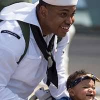 US Navy 090801-N-0327S-027 Fire Controlman 2nd Class Daniel Boes, assigned  to the amphibious dock landing ship USS Comstock (LSD 45), holds his  daughter for the first time after returning from a scheduled
