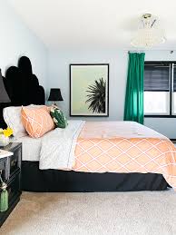 This is a primary bedroom with an electric feel to it due to the contrast of green walls and ceiling with the bright orange area rug and bed. My Best Bright Cheery Spaces It S A Colorful Life Spring Home Tour