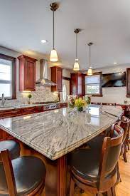 The light gold tones of the granite, contrasting with dark brown variations, can tie the design features together for a bold effect. Viscont White Granite Countertops With Cherry Cabinets Modern Kuche Boston Von Stone Projects Houzz
