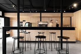 Black And White Cafe Interior Design This Cafe In Mexico Used Pegboard Walls For A Simple Interior Design Solution Simple Interior Design Interior Design Solutions Simple Interior