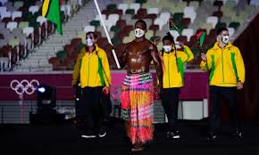 Riilio rii, of vanuatu, carries his country's flag during the opening ceremony in the olympic stadium at the 2020 summer olympics, friday, . 9gopxu1lrdiyvm