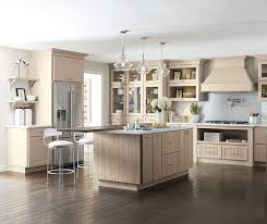 Simple white cabinets and clean silver hardware work well alongside wooden countertops and light colored wall paint. Transitional Kitchen With Beige Cabinets Kemper