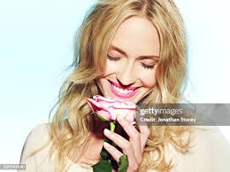 1 289 Young Woman And Beautiful And Holding A Single Flower Stock Photos,  High-Res Pictures, and Images