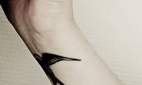 On the man's shoulder, a monochrome clock is shown, from this clock fly black birds, they are placed on the chest. Bird Tattoo On Wrist For Men