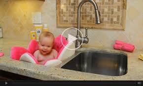 Baby taking bath in the kitchen sink. Blooming Bath Lotus Baby Bath Baby Bath Seat Baby Bath Tub Baby Bath Baby Bathtub