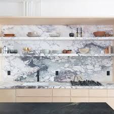 This tiled green kitchen splashback is a stunning feature piece against the crisp white panelling and cabinetry in this home. Ten Compact Kitchens By Architects That Make The Most Of Limited Space