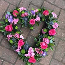 Close up of a funeral sheaf. The Florist Loughton Funeral Flowers Hearts And Crosses
