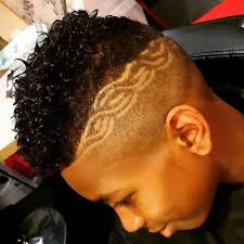 The shortest haircut represents a buzzed style with a few lined details. 15 Excellent Curly Haircuts For Black Boys Styling Tips Cool Men S Hair