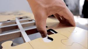 Before you can enjoy this modern looking coffee table, you must first assemble the jigsaw puzzle surface. The Jigsaw Puzzle Coffee Table By Unnecessary Inventions Kickstarter