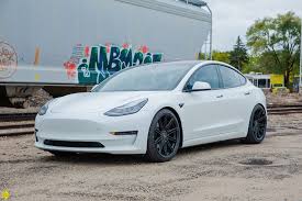 The metal structure is a combination of aluminum and steel, for maximum strength in every area. White Tesla Model 3 Momo Barletta Wheels In Matte Black Momo