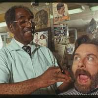 Louis McDowell pretends to give fieldworker David Taylor a shave and a  haircut.