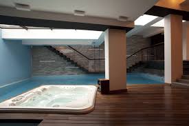 Modern Underground Indoor Pool And Hot Tub With Wood Deck And Brick Wall Indoor Pool Indoor Pool Design Pool Designs