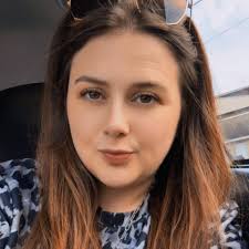 Man in red car approaches child at ball field