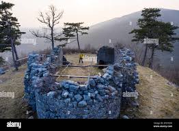 Aerial shot of boy hiking around remains of ruined church Sveta Katarina  (St Catherine), Karst, Slovenia Stock Photo