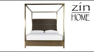 Brushed brass finished poster bed with dark grey velvet upholstered headboard. Modern Hollywood Regency Brass Harlow King Canopy Bed 656a290b Zin Home Universal Youtube