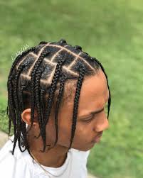 While there's a small section of hair up front that is loose to tuck behind ears, most of the top half of the short box braids is pulled back into a cute messy ponytail. Men Box Braids