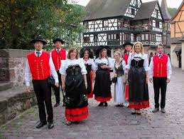 Both his vest and waistcoat are adorned with shiny golden. What You Need To Know About The Alsace Region French Moments Traditional Outfits Traditional Dresses Traditional French Clothing