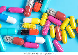 Home alternative pain remedy, opioid addiction, dangerous painkiller, overdose. Green Yellow Red And Pink Pills Or Capsules On A Blue Background Medicine Green Yellow Red And Pink Pills Or Capsules On Canstock
