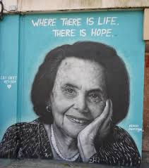 שתי הנשים העומדות כאן הן האחיות פרידל (משמאל) ואיטה (מימין) דויטש. תמונה זו  צולמה באפריל 1945, מיד לאחר שחרור ברגן בלזן, הנשים מקבלות בגדים. לרוע המזל  פרידל (שנעזרת באיטה בתמונה משום שהיא