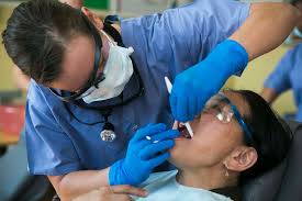 U.S. Navy Lt. Melissa Thomas, left, administers dental