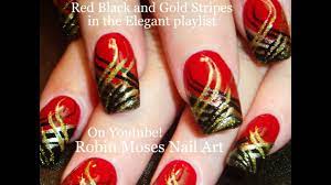 Two nails are red, one is sparkly black and other is glittery gold. Nail Art Diy Red Nails With Stripes Black And Gold Nail Design Tutorial Youtube