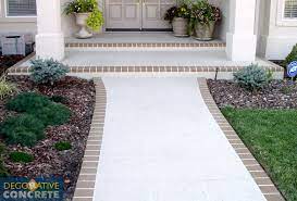 The rough texture of brick also makes for surer footing in wet weather. Beautiful Cream Walkway And Front Porch With Brick Edging Created By Decorative Concrete Brick Edging Concrete Walkway Front Walkway