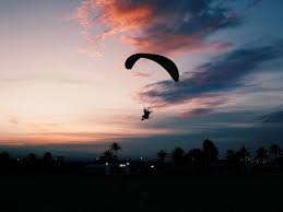 At sunset, skydivers freefall over texas before deploying their parachutes. Hd Wallpaper Silhouette Of Man Parachuting Under Gray Sky Silhouette Photo Of Man Skydiving Landing On Land At Noontime Wallpaper Flare