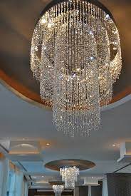 Beautiful Crystal Chandeliers Hang In The Lobby Crystal Chandelier Chandelier Design Beautiful Chandelier