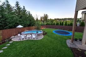 A trampoline with net is great for keeping everyone safe from injury. Backyard Landscaping Paradise Restored Landscaping