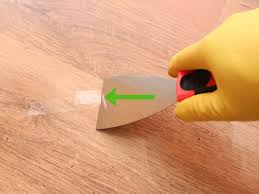 This article presumes that your floor is flat and ready to accept glue, and if concrete, is dry as you must remove all your baseboard, since it is rarely the right height to allow the flooring to slide underneath.and trim the base of the casings (door trim). 4 Ways To Remove Adhesive From A Hardwood Floor Wikihow