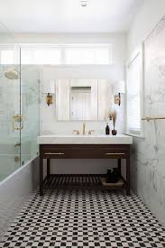 Black And White Marble Floor Tiles Black And White Marble Floor Tiles Lead To A Brown Sink Vanity Adorned With Long Brass Pulls Topped White Bathroom Mirror Bath Renovation Circa Lighting Sconce