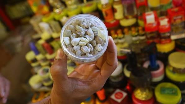 Spice vendor in Mutrah souk displaying colorful frankincense and traditional spices