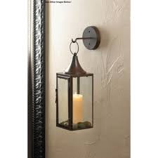Traditional tabletop holders are available with intricate design patterns able large living spaces will enjoy the ambiance of a floor candelabrum while bare walls can be enhanced with beautiful sconces. Candle Holders For Wall Hurricane Large Wrought Iron Hanging Lantern Sconce Hook Buy Online In Jordan At Jordan Desertcart Com Productid 42830947