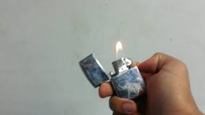 Turn it over and lift the felt pad to reveal the packing material in the fuel chamber. How To Light A Zippo Lighter Youtube