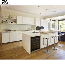 Featuring a wooden kitchen island with granite countertop, dual sink, breakfast top, chairspace, and storage, this kitchen is also in the unique position of facing a beautiful body of water. China Popular Luxury Kitchen Island White Lacquer Modern Cupboards China Kitchen Cabinets Kitchen Furniture
