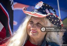 Former president Donald Trump supporterLibby Depiero holds a sign near  Mar-a-Lago in Palm Beach, Florida