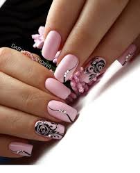 Pink theme manicure with black and grey feather and tribal designs. Cute Pink And Black Nail Design
