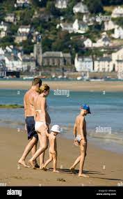 Young family on Ynyslas beach and sands, Borth Ceredigion wales with  Aberdyfi accross the estuary in the distance Stock Photo - Alamy