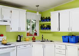 So instead of applying another layer of glazing which would most likely hardly show on the dark paint surface, the raised edges of the moldings were simply sanded down and resealed to achieve a distressed effect. Kitchen Cabinet Makeover A Before And After Project With Paint