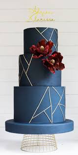 Wedding cake decorated with flowers on the table at a wedding banquet. 22 Clean And Contemporary Wedding Cakes Navy Blue And Marsala Wedding Cake