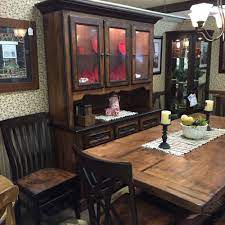 The worn wood table is paired with chairs of different shapes, colors and materials, each standing out from the rest in its unique way. Old Time Country Table With Fireside Furniture In Pompton Plains Nj