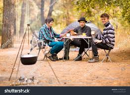 Group Of People Sitting At Tourist Table And Eating Food Cooked On Fire Camp Food Group Of Young People In Cas People Sitting Animal Logo Inspiration Tourist