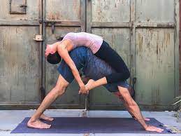 Begin in easy pose facing away from each other so that your backs are pressing into one another. Couples Yoga Poses 23 Easy Medium Hard Yoga Poses For Two People