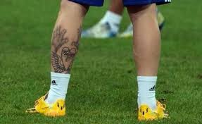 A tattoo of jesus' face with a crown of positions of royalty sits upon this football legends right arm. Lionel Messis Love For His Tattoos Is Beyond Words
