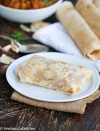 Add water, potato, carrots, scallions, ginger, and chile pepper to skillet. Trinidad Chicken Roti Immaculate Bites