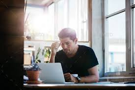 Business Man Thinking About A Problem At His Laptop Business Photos Business Logo Design Business Man