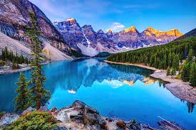 This peaceful pathway starts from beside the moraine lake lodge and follows along the shoreline of the lake as it passes through a gorgeous lush forest. Sunrise At Moraine Lake By Wan Ru Chen