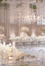 Hang them with tape for a dramatic effect when walking into the party. White Wedding Decoration Ideas See More Https Www Weddingforward Com White Silver Wedding Decorations White Wedding Decorations Extravagant Wedding Decor